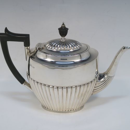 A very handsome Antique Victorian Sterling Silver Queen Anne style four-piece tea and coffee set consisting of a coffee pot, tea-pot, sugar bowl, and milk / cream jug, having oval bodies with hand-chased half-fluted decoration and applied reeded borders, with wooden handles and finials, and all sitting on collet feet. All made by James Dixon and Sons of Sheffield in 1894. The dimensions of this fine hand-made antique silver tea and coffee service are length of teapot 25.5 cms (10 inches), height of coffee pot 23.5 cms (9.25 inches), and the total weight is approx. 1,500g (48 troy ounces).  