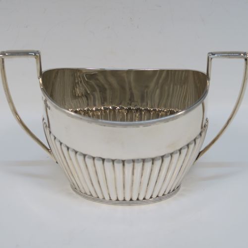 A very handsome Antique Victorian Sterling Silver Queen Anne style four-piece tea and coffee set consisting of a coffee pot, tea-pot, sugar bowl, and milk / cream jug, having oval bodies with hand-chased half-fluted decoration and applied reeded borders, with wooden handles and finials, and all sitting on collet feet. All made by James Dixon and Sons of Sheffield in 1894. The dimensions of this fine hand-made antique silver tea and coffee service are length of teapot 25.5 cms (10 inches), height of coffee pot 23.5 cms (9.25 inches), and the total weight is approx. 1,500g (48 troy ounces).  