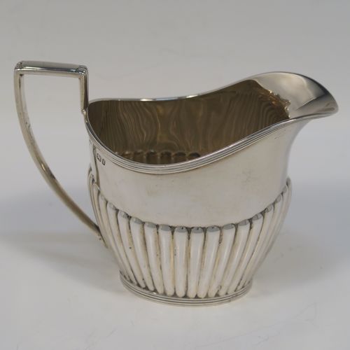A very handsome Antique Victorian Sterling Silver Queen Anne style four-piece tea and coffee set consisting of a coffee pot, tea-pot, sugar bowl, and milk / cream jug, having oval bodies with hand-chased half-fluted decoration and applied reeded borders, with wooden handles and finials, and all sitting on collet feet. All made by James Dixon and Sons of Sheffield in 1894. The dimensions of this fine hand-made antique silver tea and coffee service are length of teapot 25.5 cms (10 inches), height of coffee pot 23.5 cms (9.25 inches), and the total weight is approx. 1,500g (48 troy ounces).  