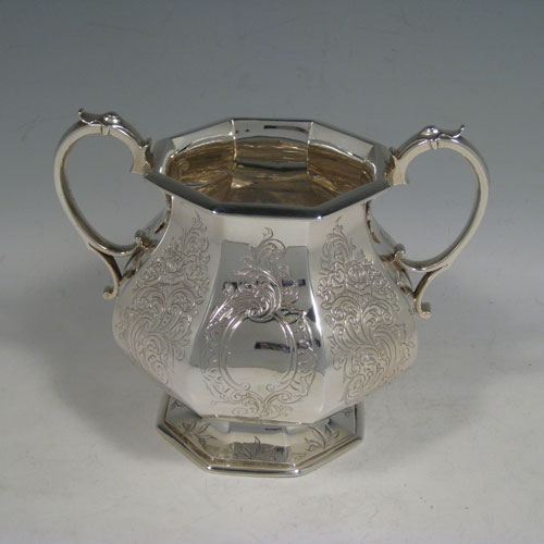 A beautiful Antique Victorian Sterling Silver four-piece tea and coffee service, consisting of a coffee pot, tea pot, sugar bowl, and cream jug, having octagonal panelled bodies with hand-engraved floral and scroll decoration, hinged lids with figural finials, and insulated silver handles. This fantastic antique silver tea and coffee service was made by William Theobald of London in 1845. The dimensions of this fine hand-made set are height of coffee pot 29 cms (11.5 inches), length of teapot 24 cms (9.5 inches), and with a total weight of approx. 2,341g (75.5 troy ounces).