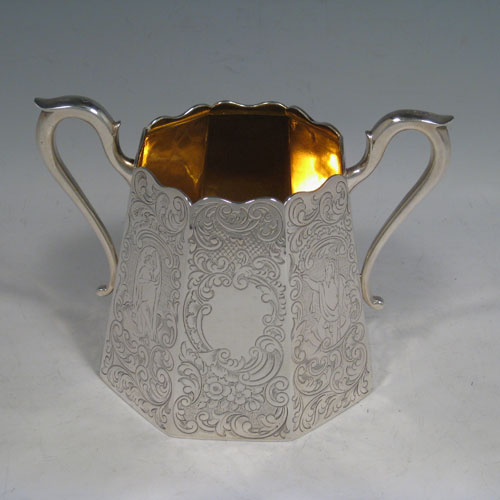 A beautiful Antique Victorian Sterling Silver four-piece tea and coffee service, consisting of a coffee pot, tea pot, sugar bowl, and cream jug, having octagonal panelled bodies with hand-engraved floral and scroll decoration, hinged lids with finials, and insulated silver handles, and gold-gilt interiors to the cream jug and sugar bowl. This impressive antique silver tea and coffee service was made by Hayne and Cater of London in 1848. The dimensions of this fine hand-made silver set are height of coffee pot 22 cms (8.75 inches), length of teapot 23 cms (9 inches), and with a total weight of approx. 1,967g (63.5 troy ounces).