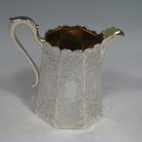 A beautiful Antique Victorian Sterling Silver four-piece tea and coffee service, consisting of a coffee pot, tea pot, sugar bowl, and cream jug, having octagonal panelled bodies with hand-engraved floral and scroll decoration, hinged lids with finials, and insulated silver handles, and gold-gilt interiors to the cream jug and sugar bowl. This impressive antique silver tea and coffee service was made by Hayne and Cater of London in 1848. The dimensions of this fine hand-made silver set are height of coffee pot 22 cms (8.75 inches), length of teapot 23 cms (9 inches), and with a total weight of approx. 1,967g (63.5 troy ounces).