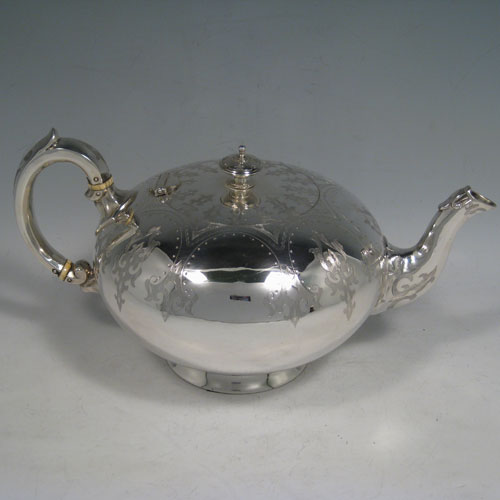 A very pretty Antique Victorian Sterling Silver four-piece tea and coffee service, consisting of a coffee pot, tea pot, sugar bowl, and cream jug, having round bodies with hand-engraved styalised decoration, hinged lids with finials, and insulated silver handles. This beautiful antique silver tea and coffee service was made by Henry Holland of London in 1865. The dimensions of this fine hand-made silver service are height of coffee pot 25.5 cms (10 inches), length of teapot 26.5 cms (10.5 inches), and with a total weight approx. 1,998g (64.5 troy ounces).
