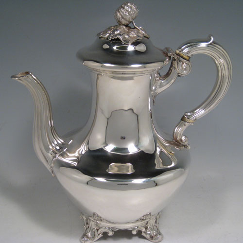    Antique Victorian sterling silver four-piece tea and coffee service, consisting of a coffee pot, tea pot, sugar bowl, and cream jug, having plain round baluster, hinged lids with floral finials, and insulated silver handles, and sitting on four floral feet. Made by the Savory Brothers of London between 1848 and 1854. Height of coffee pot 25.5 cms (10 inches), length of teapot 29 cms (11.5 inches). Total weight approx. 2,138g (70 troy ounces).
