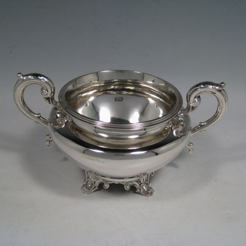    Antique Victorian sterling silver four-piece tea and coffee service, consisting of a coffee pot, tea pot, sugar bowl, and cream jug, having plain round baluster, hinged lids with floral finials, and insulated silver handles, and sitting on four floral feet. Made by the Savory Brothers of London between 1848 and 1854. Height of coffee pot 25.5 cms (10 inches), length of teapot 29 cms (11.5 inches). Total weight approx. 2,138g (70 troy ounces).
