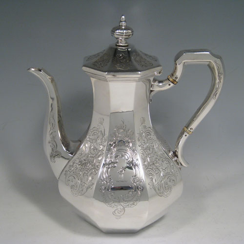 A very pretty Antique Victorian Sterling Silver four-piece tea and coffee service, consisting of a coffee pot, tea pot, sugar bowl, and cream jug, having octagonal panelled bodies with hand-engraved floral and scroll decoration, hinged lids with finials, and insulated silver handles. This beautiful antique silver tea and coffee set was made by William Kerr Reid of London in 1850. The dimensions of this fine hand-made silver service are height of coffee pot 25 cms (10 inches), length of teapot 23.5 cms (9.25 inches), and with a total weight approx. 1,740g (56 troy ounces).