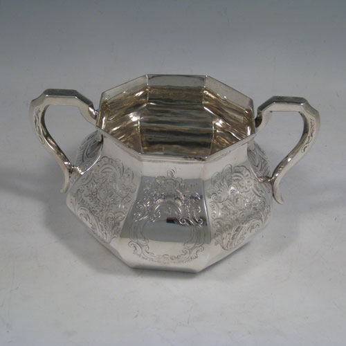 A very pretty Antique Victorian Sterling Silver four-piece tea and coffee service, consisting of a coffee pot, tea pot, sugar bowl, and cream jug, having octagonal panelled bodies with hand-engraved floral and scroll decoration, hinged lids with finials, and insulated silver handles. This beautiful antique silver tea and coffee set was made by William Kerr Reid of London in 1850. The dimensions of this fine hand-made silver service are height of coffee pot 25 cms (10 inches), length of teapot 23.5 cms (9.25 inches), and with a total weight approx. 1,740g (56 troy ounces).