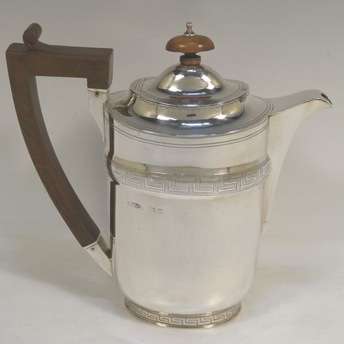 A very elegant Sterling Silver Georgian style four-piece tea and coffee service, consisting of a teapot, hot water or coffee pot, sugar bowl and cream jug. Having plain oval bodies with bands of hand-engraved Greek-Key decoration, the teapot and water pot with wooden handles and finials, the cream jug and sugar bowl with applied reeded borders, and all sitting on collet feet. This handsome silver tea and coffee service was made by James Dixon and Sons of Sheffield in 1939. The dimensions of this fine hand-made tea and coffee set are length of teapot 27.5 cms (10.75 inches), height of coffee pot 18.5 cms (7.25 inches), and the total weight is approx. 1,300g (42 troy ounces).