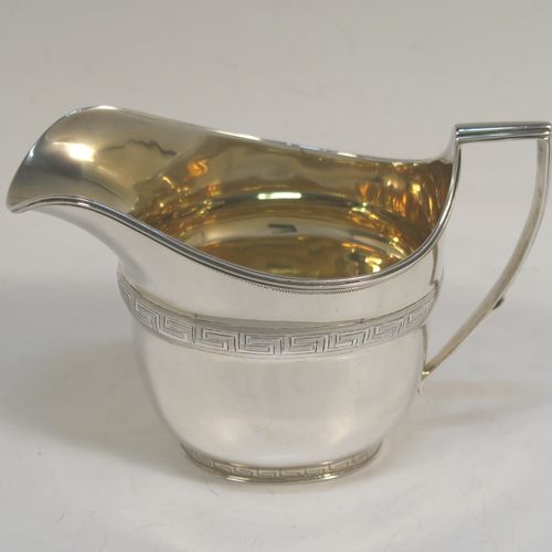 A very elegant Sterling Silver Georgian style four-piece tea and coffee service, consisting of a teapot, hot water or coffee pot, sugar bowl and cream jug. Having plain oval bodies with bands of hand-engraved Greek-Key decoration, the teapot and water pot with wooden handles and finials, the cream jug and sugar bowl with applied reeded borders, and all sitting on collet feet. This handsome silver tea and coffee service was made by James Dixon and Sons of Sheffield in 1939. The dimensions of this fine hand-made tea and coffee set are length of teapot 27.5 cms (10.75 inches), height of coffee pot 18.5 cms (7.25 inches), and the total weight is approx. 1,300g (42 troy ounces).