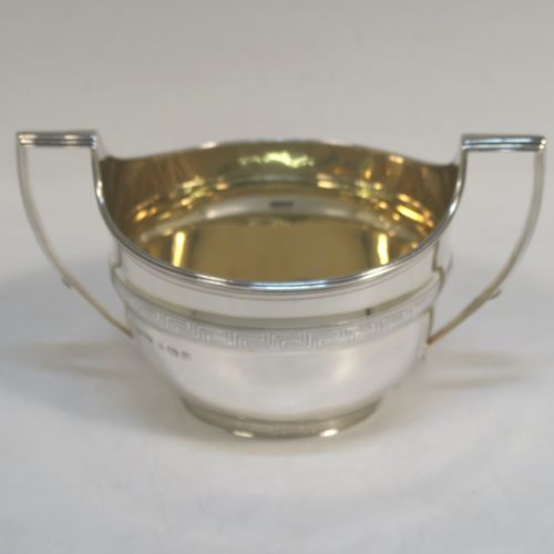 A very elegant Sterling Silver Georgian style four-piece tea and coffee service, consisting of a teapot, hot water or coffee pot, sugar bowl and cream jug. Having plain oval bodies with bands of hand-engraved Greek-Key decoration, the teapot and water pot with wooden handles and finials, the cream jug and sugar bowl with applied reeded borders, and all sitting on collet feet. This handsome silver tea and coffee service was made by James Dixon and Sons of Sheffield in 1939. The dimensions of this fine hand-made tea and coffee set are length of teapot 27.5 cms (10.75 inches), height of coffee pot 18.5 cms (7.25 inches), and the total weight is approx. 1,300g (42 troy ounces).