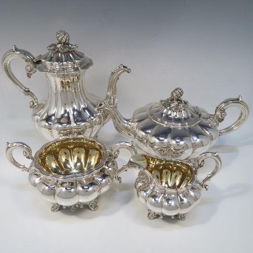 A beautiful Antique Victorian Sterling Silver four-piece tea and coffee service, in the Melon fluted style, having round hand-chased bodies, hinged lids with cast floral finials, insulated silver scroll handles, gold-gilt interiors, and all sitting on cast shell and scroll feet. This fantastic silver tea and coffee service was made by the Barnard Brothers of London in 1835/1836. The dimensions of this fine hand-made antique silver tea and coffee set are height of coffee pot 25.5 cms (10 inches), length of teapot 30.5 cms (10 inches), and with a total weight of approx. 2,232g (72 troy ounces).   