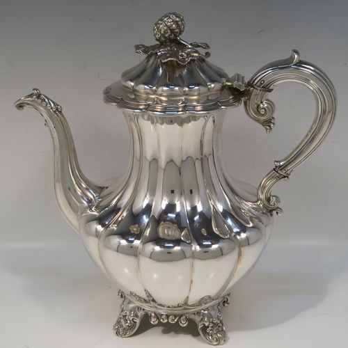 A beautiful Antique Victorian Sterling Silver four-piece tea and coffee service, in the Melon fluted style, having round hand-chased bodies, hinged lids with cast floral finials, insulated silver scroll handles, gold-gilt interiors, and all sitting on cast shell and scroll feet. This fantastic silver tea and coffee service was made by the Barnard Brothers of London in 1835/1836. The dimensions of this fine hand-made antique silver tea and coffee set are height of coffee pot 25.5 cms (10 inches), length of teapot 30.5 cms (10 inches), and with a total weight of approx. 2,232g (72 troy ounces).