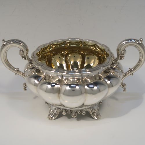 A beautiful Antique Victorian Sterling Silver four-piece tea and coffee service, in the Melon fluted style, having round hand-chased bodies, hinged lids with cast floral finials, insulated silver scroll handles, gold-gilt interiors, and all sitting on cast shell and scroll feet. This fantastic silver tea and coffee service was made by the Barnard Brothers of London in 1835/1836. The dimensions of this fine hand-made antique silver tea and coffee set are height of coffee pot 25.5 cms (10 inches), length of teapot 30.5 cms (10 inches), and with a total weight of approx. 2,232g (72 troy ounces).