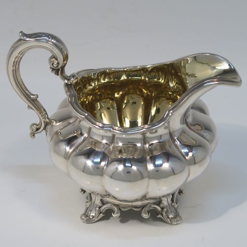 A beautiful Antique Victorian Sterling Silver four-piece tea and coffee service, in the Melon fluted style, having round hand-chased bodies, hinged lids with cast floral finials, insulated silver scroll handles, gold-gilt interiors, and all sitting on cast shell and scroll feet. This fantastic silver tea and coffee service was made by the Barnard Brothers of London in 1835/1836. The dimensions of this fine hand-made antique silver tea and coffee set are height of coffee pot 25.5 cms (10 inches), length of teapot 30.5 cms (10 inches), and with a total weight of approx. 2,232g (72 troy ounces).