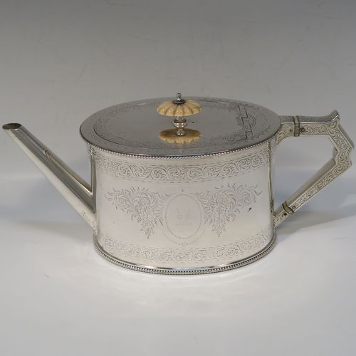 A very pretty Antique Victorian Sterling Silver four-piece tea and coffee service, consisting of a coffee pot, tea pot, sugar bowl, and cream jug, in a Can or Lighthouse style having oval straight-sided bodies with hand-engraved floral and scroll decoration and applied bead-edged borders, flat hinged lids with bone finials, and insulated silver handles, all sitting on flat bases. This beautiful silver tea and coffee service was made by Elkington and Co., of Birmingham in 1887. The dimensions of this fine hand-made antique silver service set are height of coffee pot 23 cms (9 inches), length of teapot 28 cms (11 inches), and with a total weight of approx. 2,180g (70 troy ounces).