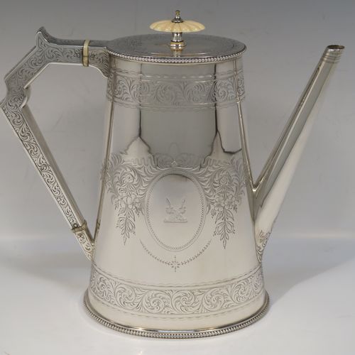 A very pretty Antique Victorian Sterling Silver four-piece tea and coffee service, consisting of a coffee pot, tea pot, sugar bowl, and cream jug, in a Can or Lighthouse style having oval straight-sided bodies with hand-engraved floral and scroll decoration and applied bead-edged borders, flat hinged lids with bone finials, and insulated silver handles, all sitting on flat bases. This beautiful silver tea and coffee service was made by Elkington and Co., of Birmingham in 1887. The dimensions of this fine hand-made antique silver service set are height of coffee pot 23 cms (9 inches), length of teapot 28 cms (11 inches), and with a total weight of approx. 2,180g (70 troy ounces).