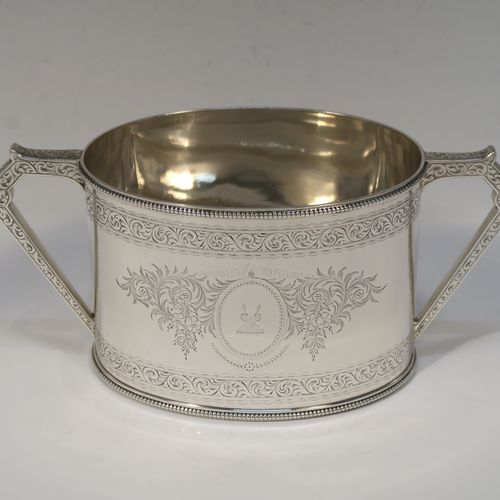 A very pretty Antique Victorian Sterling Silver four-piece tea and coffee service, consisting of a coffee pot, tea pot, sugar bowl, and cream jug, in a Can or Lighthouse style having oval straight-sided bodies with hand-engraved floral and scroll decoration and applied bead-edged borders, flat hinged lids with bone finials, and insulated silver handles, all sitting on flat bases. This beautiful silver tea and coffee service was made by Elkington and Co., of Birmingham in 1887. The dimensions of this fine hand-made antique silver service set are height of coffee pot 23 cms (9 inches), length of teapot 28 cms (11 inches), and with a total weight of approx. 2,180g (70 troy ounces).