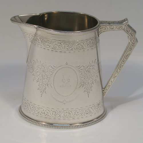 A very pretty Antique Victorian Sterling Silver four-piece tea and coffee service, consisting of a coffee pot, tea pot, sugar bowl, and cream jug, in a Can or Lighthouse style having oval straight-sided bodies with hand-engraved floral and scroll decoration and applied bead-edged borders, flat hinged lids with bone finials, and insulated silver handles, all sitting on flat bases. This beautiful silver tea and coffee service was made by Elkington and Co., of Birmingham in 1887. The dimensions of this fine hand-made antique silver service set are height of coffee pot 23 cms (9 inches), length of teapot 28 cms (11 inches), and with a total weight of approx. 2,180g (70 troy ounces).