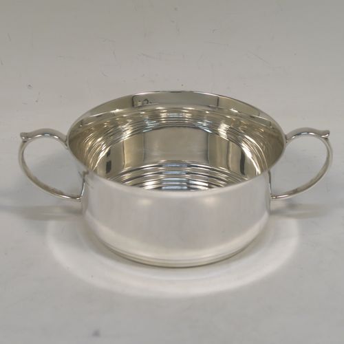 A very handsome and stylish Sterling Silver Art Deco style four-piece tea and coffee service, having very plain round bodies, with brown stained wooden handles and finials, and all sitting on flat stepped bases. This very elegant silver tea and coffee service was made by Alvic Products Ltd., of Birmingham in 1947. The dimensions of this fine hand-made Art Deco style tea and coffee set are length of teapot 23 cms (9 inches), height of coffee pot 15 cms (6 inches), and the total weight is approx. 1,127g (36 troy ounces).