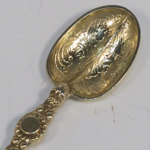 A beautiful set of twelve Antique Victorian Sterling Silver and gold-gilt coffee spoons, in the Coronation Anointing pattern with hand-engraved floral decoration to the bowls, and cast ornate handles, all in their original cream satin and maroon velvet-lined presentation box. These pretty antique silver and gold-gilt coffee spoons were made by Wakely and Wheeler of London in 1901. The dimensions of this fine hand-made antique silver set of coffee spoons are length of each spoon 10.5 cms (4.25 inches), and the total weight is approx. 135g (4.4 troy ounce).