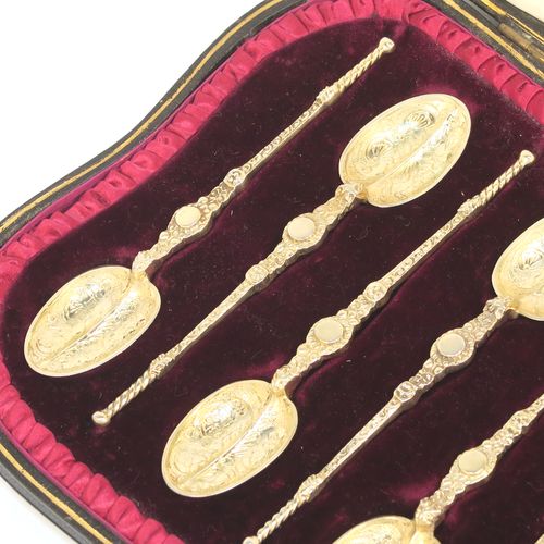 A beautiful set of twelve Antique Victorian Sterling Silver and gold-gilt coffee spoons, in the Coronation Anointing pattern with hand-engraved floral decoration to the bowls, and cast ornate handles, all in their original cream satin and maroon velvet-lined presentation box. These pretty antique silver and gold-gilt coffee spoons were made by Wakely and Wheeler of London in 1901. The dimensions of this fine hand-made antique silver set of coffee spoons are length of each spoon 10.5 cms (4.25 inches), and the total weight is approx. 135g (4.4 troy ounce).