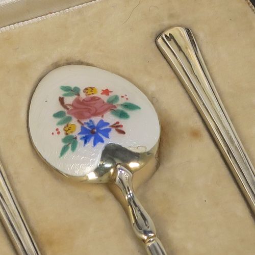 An extremely pretty Antique Sterling Silver and enamelled set of six tea or coffee spoons, having hand-painted and enamelled spoon backs in a floral design, all in their original cream satin and velvet-line presentation box. These beautiful antique silver and enamelled spoons were made by Turner and Simpson of Birmingham in 1915. The dimensions of this fine hand-made set of silver and enamelled teaspoons or coffee spoons are length of each spoon 10 cms (4 inches), and the total weight is approx. 66g (2.1 troy ounces). Please note that the enamel is in perfect order which is rare to find in spoons of this age.