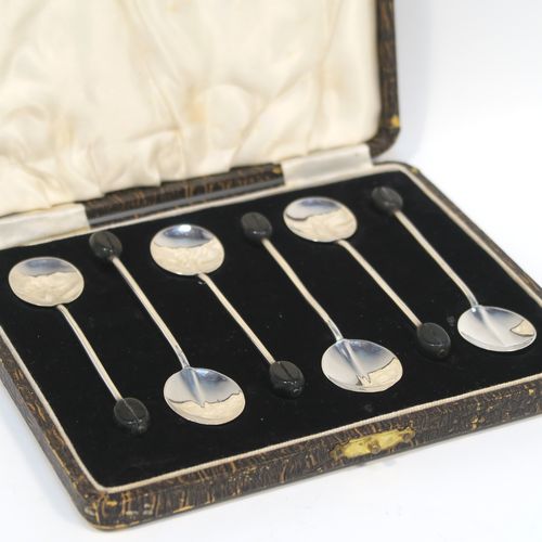 A handsome set of six Sterling Silver coffee spoons, having plain round bowls, and plain stems with wooden black stained coffee bean ends, all in their original cream satin and black velvet-lined presentation box. These elegant silver coffee spoons were made by the Adie Brothers of Birmingham in 1930. The dimensions of this fine hand-made set of coffee spoons are length of each spoon 9 cms (3.5 inches), and the total weight is approx. 31g (1 troy ounce).   