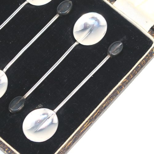 A handsome set of six Sterling Silver coffee spoons, having plain round bowls, and plain stems with wooden black stained coffee bean ends, all in their original cream satin and black velvet-lined presentation box. These elegant silver coffee spoons were made by the Adie Brothers of Birmingham in 1930. The dimensions of this fine hand-made set of coffee spoons are length of each spoon 9 cms (3.5 inches), and the total weight is approx. 31g (1 troy ounce).