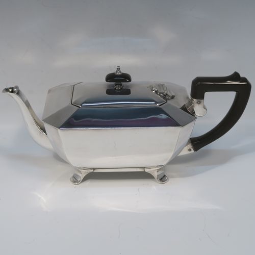 A very handsome and stylish Art Deco Silver-Plated three-piece tea set, consisting of a teapot, sugar bowl, and cream jug, in a plain rectangular panelled style, with the teapot having a wooden handle with matching finial and a hinged lid, the cream jug and sugar bowl having angular handles and spout, and all sitting on four cast flanged feet. This elegant silver plated tea set was made by James Dixon and Sons of Sheffield in ca. 1930. The dimensions of this fine hand-made Art Deco silver-plated three-pieced tea set are height of teapot 13 cms (5 inches), length 28 cms (11 inches), and width 12 cms (4.75 inches).