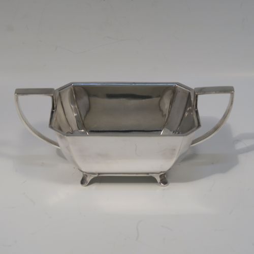 A very handsome and stylish Art Deco Silver-Plated three-piece tea set, consisting of a teapot, sugar bowl, and cream jug, in a plain rectangular panelled style, with the teapot having a wooden handle with matching finial and a hinged lid, the cream jug and sugar bowl having angular handles and spout, and all sitting on four cast flanged feet. This elegant silver plated tea set was made by James Dixon and Sons of Sheffield in ca. 1930. The dimensions of this fine hand-made Art Deco silver-plated three-pieced tea set are height of teapot 13 cms (5 inches), length 28 cms (11 inches), and width 12 cms (4.75 inches).