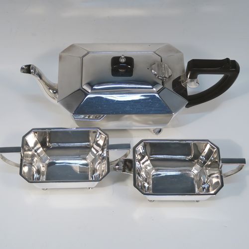 A very handsome and stylish Art Deco Silver-Plated three-piece tea set, consisting of a teapot, sugar bowl, and cream jug, in a plain rectangular panelled style, with the teapot having a wooden handle with matching finial and a hinged lid, the cream jug and sugar bowl having angular handles and spout, and all sitting on four cast flanged feet. This elegant silver plated tea set was made by James Dixon and Sons of Sheffield in ca. 1930. The dimensions of this fine hand-made Art Deco silver-plated three-pieced tea set are height of teapot 13 cms (5 inches), length 28 cms (11 inches), and width 12 cms (4.75 inches).