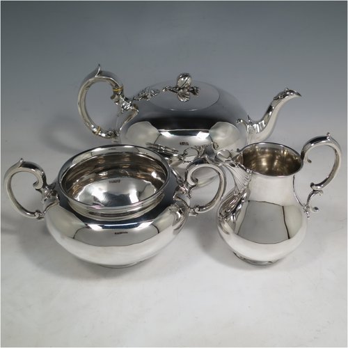 An Antique Victorian Sterling Silver three-piece  tea set, consisting of a teapot, sugar bowl and cream jug. The bodies in a plain round style with scroll handles, the teapot with silver handle and finial, and all sitting on collet feet. Made by the Barnard Brothers of London in 1847. The dimensions of this fine hand-made antique silver tea service are length of teapot 26 cms (10.25 inches), height 13.5 cms (5.25 inches), and it weighs a total of approx. 1,101g (35.5 troy ounces).   