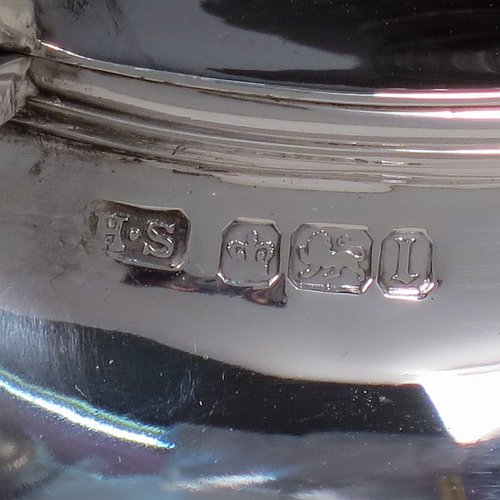 An elegant Antique Victorian Sterling Silver three-piece tea set, having oval shaped bodies, with fine half-fluted and reeded hand-chased decoration, reeded handles on the sugar & cream jug together with gold-gilt interiors, and a wooden handle & finial on the teapot, and all sitting on collet foot bases. This handsome silver tea service was made by Henry Stratford of Sheffield in 1900. The dimensions of this fine hand-made antique silver tea set are length of teapot 28 cms (11 inches), height 15 cms (6 inches), and the total weight is approx. 775g (25 troy ounces).