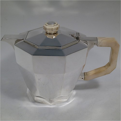 A very handsome and heavy Sterling Silver Art Deco three-piece tea set, consisting of a teapot, sugar bowl, and cream jug, in a plain octagonal panelled style with hand-cut handles and matching finial, the teapot with a hinged lid, and all sitting on octagonal collet feet. Made by Elkington and Co., of Birmingham in 1934/35. The dimensions of this fine hand-made Art Deco silver tea set are height of teapot 15 cms (6 inches), length 23 cms (9 inches), and it weighs a total of approx. 1,100g (35.5 troy ounces).
