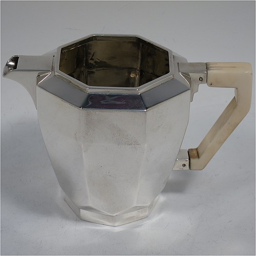 A very handsome and heavy Sterling Silver Art Deco three-piece tea set, consisting of a teapot, sugar bowl, and cream jug, in a plain octagonal panelled style with hand-cut handles and matching finial, the teapot with a hinged lid, and all sitting on octagonal collet feet. Made by Elkington and Co., of Birmingham in 1934/35. The dimensions of this fine hand-made Art Deco silver tea set are height of teapot 15 cms (6 inches), length 23 cms (9 inches), and it weighs a total of approx. 1,100g (35.5 troy ounces).