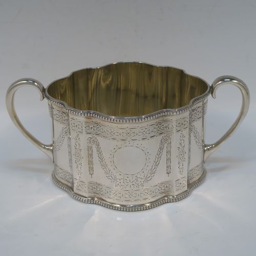 A heavy and very pretty Antique Victorian Sterling Silver three-piece tea set, consisting of a teapot, sugar bowl, and cream jug, having shaped oval bodies with straight sides, applied bead-edged borders, and hand-engraved Neoclassical style decoration, the teapot with a black wooden handle, finial, and a hinged lid with a flat invisible hinge, the sugar and creamer with scroll handles, gold-gilt interiors, and all sitting on flat bases. This beautiful silver three-piece tea set was made by Joseph Angell II and Robert Harper of London in 1872. The dimensions of this fine hand-made silver tea set are height of teapot 13.5 cms (5.3 inches), length 29 cms (11.5 inches), and it weighs a total of approx. 1,240g (44 troy ounces).