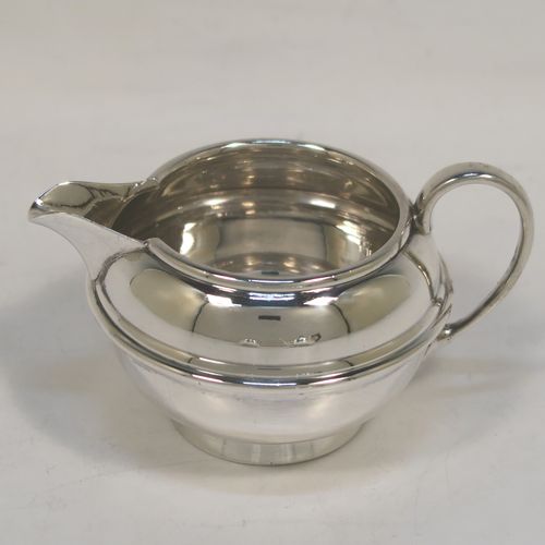 A very handsome Antique Sterling Silver Bachelor three-piece tea set, having plain round bellied shaped bodies, with central applied bands and loop handles, the teapot with a wooden handle and finial, and all sitting on round collet feet. This elegant antique silver bachelor tea set was all made by S. W. Smith and Co., of Birmingham in 1922. The dimensions of this fine hand-made antique silver bachelor tea set are length of teapot 20.5 cms (8 inches), height 10 cms (4 inches), and the total weight is approx. 468g (15 troy ounces).