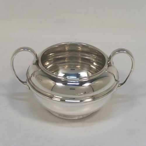 A very handsome Antique Sterling Silver Bachelor three-piece tea set, having plain round bellied shaped bodies, with central applied bands and loop handles, the teapot with a wooden handle and finial, and all sitting on round collet feet. This elegant antique silver bachelor tea set was all made by S. W. Smith and Co., of Birmingham in 1922. The dimensions of this fine hand-made antique silver bachelor tea set are length of teapot 20.5 cms (8 inches), height 10 cms (4 inches), and the total weight is approx. 468g (15 troy ounces).