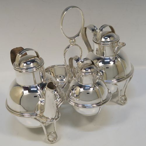 A very stylish and unusual Antique Edwardian Silver-Plated four-piece tea set in a Guernsey style, consisting of teapot, hot-water pot, sugar bowl, and cream jug, all in their original wire-work carrying stand. This beautiful antique silver plated tea set was made by James Collyer of Sheffield in ca. 1910. The dimensions of this fine hand-made antique silver-plated Guernsey tea set and carrying frame are height 21 cms (8.25 inches), length 26.5 cms (10.5 inches), and width 18 cms (7 inches).   