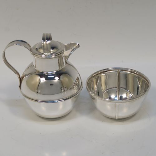 A very stylish and unusual Antique Edwardian Silver-Plated four-piece tea set in a Guernsey style, consisting of teapot, hot-water pot, sugar bowl, and cream jug, all in their original wire-work carrying stand. This beautiful antique silver plated tea set was made by James Collyer of Sheffield in ca. 1910. The dimensions of this fine hand-made antique silver-plated Guernsey tea set and carrying frame are height 21 cms (8.25 inches), length 26.5 cms (10.5 inches), and width 18 cms (7 inches).