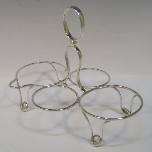 A very stylish and unusual Antique Edwardian Silver-Plated four-piece tea set in a Guernsey style, consisting of teapot, hot-water pot, sugar bowl, and cream jug, all in their original wire-work carrying stand. This beautiful antique silver plated tea set was made by James Collyer of Sheffield in ca. 1910. The dimensions of this fine hand-made antique silver-plated Guernsey tea set and carrying frame are height 21 cms (8.25 inches), length 26.5 cms (10.5 inches), and width 18 cms (7 inches).