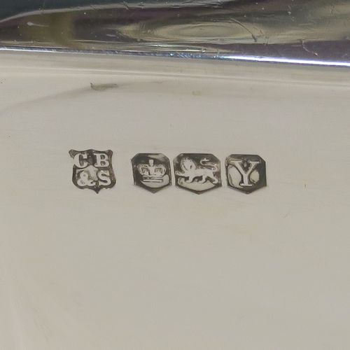 A very handsome Sterling Silver Art Deco style three-piece tea set, consisting of a teapot, sugar bowl, and cream jug, having plain panelled bodies and angular handles, the teapot with a black wooden handle, finial, and a hinged lid, and all sitting on collet feet. This elegant silver tea set was made by the Cooper Brothers of Sheffield in 1966. The dimensions of this fine hand-made Art Deco style silver tea set are height of teapot 13.5 cms (5.3 inches), length 28 cms (11 inches), and it weighs a total of approx. 1,062g (34 troy ounces).