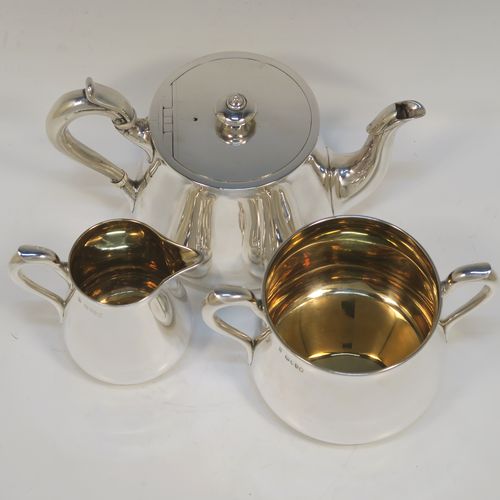 A very handsome Antique Victorian Sterling Silver three-piece tea set, consisting of a teapot, sugar bowl and cream jug. The bodies in a plain round bellied style with scroll handles, the teapot with a flat topped hinged lid and a silver handle and finial, the sugar bowl and cream jug with gold-gilt interiors, and all sitting on flat bases. This elegant silver tea set was made by Hunt and Roskell of London in 1878. The dimensions of this fine hand-made antique silver tea service are length of teapot 20 cms (8 inches), height 12.5 cms (5 inches), and it weighs a total of approx. 950g (31 troy ounces).  