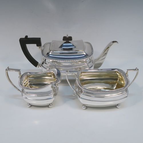A handsome Antique Edwardian Sterling silver three-piece tea and coffee set, in a Georgian style having plain rectangular bellied bodies and applied gadroon borders, the teapot with invisibly hinged lid, wooden finial and handle, and all sitting on four ball feet. This elegant silver tea set was made by James Dixon and Sons of Sheffield in 1905. The dimensions of this fine hand-made antique silver tea service are length of teapot 29 cms (11.5 inches), height 13.5 cms (5.3 inches), and the total weight is approx. 1,200g (39 troy ounces).   