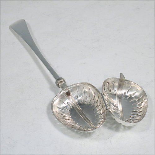 An Antique Victorian Sterling Silver tea infuser spoon, having a hand-pierced oval body, with hinged opening and patented screw-thread closing mechanism, all attached to a plain Old English pattern handle bearing the Teaette patent registration number. Made by George Gray of London in 1894. The dimensions of this fine hand-made antique silver tea infuser spoon are length 14 cms (5.5 inches), and it weighs approx. 47g (1.5 troy ounce).