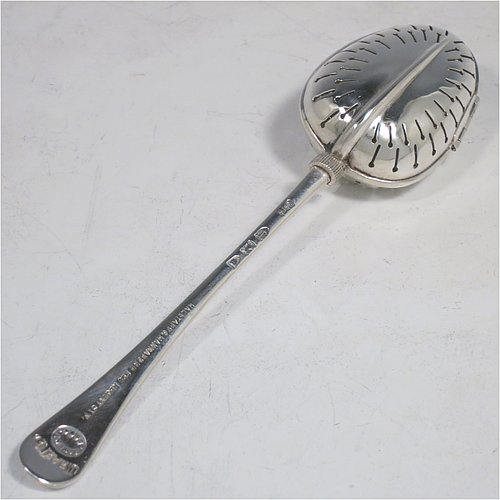 An Antique Victorian Sterling Silver tea infuser spoon, having a hand-pierced oval body, with hinged opening and patented screw-thread closing mechanism, all attached to a plain Old English pattern handle bearing the Teaette patent registration number. Made by George Gray of London in 1894. The dimensions of this fine hand-made antique silver tea infuser spoon are length 14 cms (5.5 inches), and it weighs approx. 47g (1.5 troy ounce).