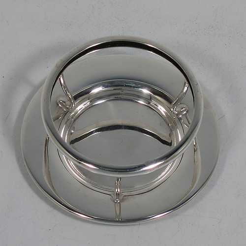 A very stylish Sterling Silver tea strainer and stand, having a round hand-pierced bowl, with wire-work loop handle and two right-angled cup supports, all sitting on an original plain round dregs stand with a wire-work galleried holder on flat base. Made by James Round of Sheffield in 1921. The dimensions of this fine hand-made silver tea strainer and stand are height 4 cms (1.5 inches), length over handle 12 cms (4.75 inches), and it weighs a total of approx. 68g (2.2 troy ounces).
