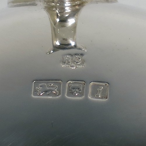 A very handsome, large, and heavy Sterling Silver tea strainer and bowl, having a plain wood-turned handle, a round hand-pierced bowl with an applied reeded border and a cast shell side holder, and sitting on a plain round dregs bowl with three cast hoof feet and shell shoulders. Made by Robert Comyns of London in 1964. The dimensions of this fine hand-made silver tea strainer & bowl are length 19 cms (7.5 inches), diameter of bowl 8 cms (3 inches), with a total weight of approx. 155g (5 troy ounces).