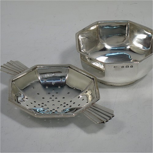 A very handsome Sterling Silver Art Deco style tea strainer and bowl, having an octagonal body with two sun-ray style side-handles, sitting on an original octagonal dregs bowl with a collet foot. Made by Hukin and Heath of Birmingham in 1937. The dimensions of this fine hand-made Art Deco sterling silver tea strainer and bowl are length 11 cms (4.3 inches), depth 6.5 cms (2.5 inches), height 3 cms (1.25 inches), with a total weight approx. 94g (3 troy ounces).