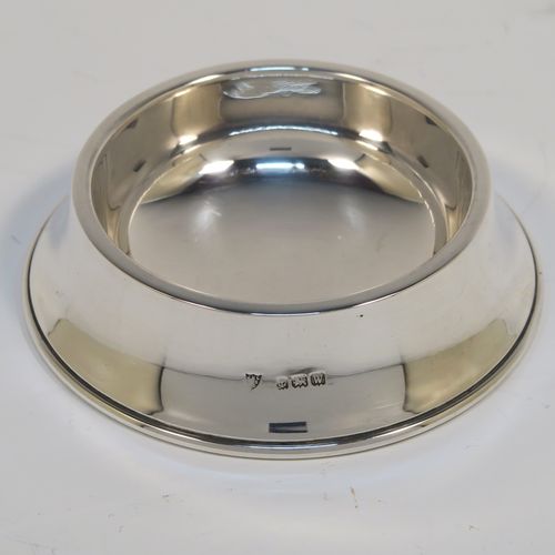 A handsome Antique Sterling Silver tea strainer and dregs bowl in a Georgian lemon strainer style, having a round hand-pierced bowl, with two side-handles, and sitting on an original plain round dregs stand. This elegant antique silver tea strainer and bowl was made by J. B. Carrington of Birmingham in 1921. The dimensions of this fine hand-made silver tea strainer and dregs stand are height 2.5 cms (1 inch), diameter of dregs stand  9.5 cms (3.75 inches), and it weighs a total of approx. 117g (3.8 troy ounces).  